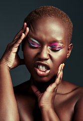 Image showing Looking flawless in color. Cropped shot of a beautiful woman wearing colorful eyeshadow while posing against a grey background.