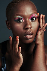 Image showing Youre always on fleek if youre wearing color. Cropped shot of a beautiful woman wearing colorful eyeshadow while posing against a grey background.