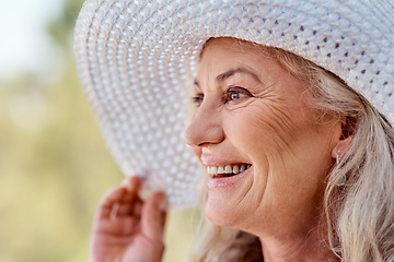 Image showing Its the season of smiles. Cropped shot of an attractive senior woman smiling while standing outdoors on a summers day.