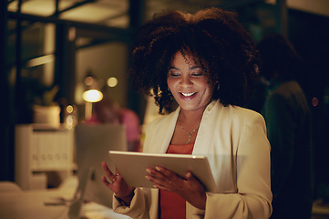 Image showing This tool will help me reach deadline so much quicker. Shot of a businesswoman using a digital tablet in an office at night.