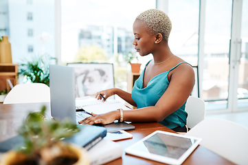 Image showing Make every minute of the workday count. Shot of a young businesswoman working at her desk in a modern office.