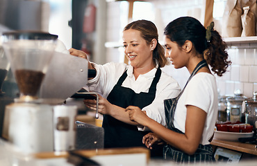 Image showing The skill behind the coffee that you love so much. Shot of two women preparing coffee in a cafe.