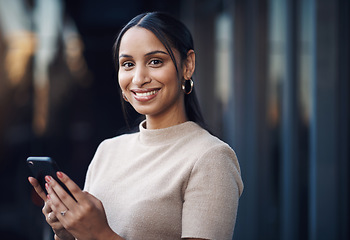 Image showing Ive just gotta send this message quickly. Cropped portrait of an attractive young businesswoman sending a text while working in her office.