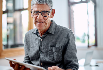 Image showing Technology always inspires me with new ideas. Portrait of a senior businessman using a digital tablet in an office.