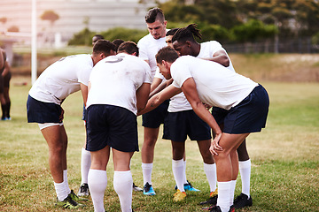 Image showing Its tough to beat a team that plays together. Shot of a group of young men joining their hands in solidarity before playing a game of rugby.