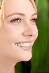 Image showing She has such a pure beauty. Headshot of a beautiful young woman against a leafy green background.