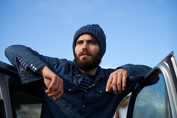 Image showing Ready to go on an adventure. A man with facial hair leaning on his car door.