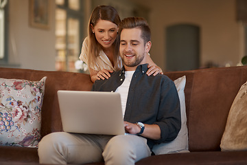 Image showing Relax, laptop and web with a couple on the living room sofa of their home together. Computer, social media or internet with a man and woman online to search while relaxing and bonding in a house