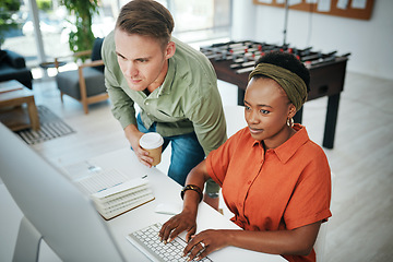 Image showing How is it going. Cropped shot of two young business colleagues working on a computer together in the office.