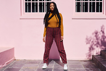 Image showing She has style and a whole lotta attitude. Shot of a beautiful young woman posing against a pink wall.