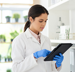 Image showing Digitising her scientific tasks. Shot of a young scientist using a digital tablet in a lab.