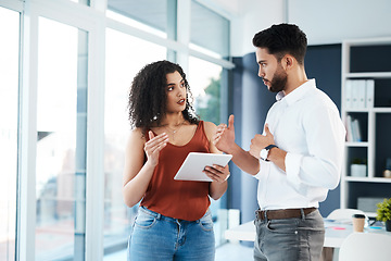 Image showing Sharing different approaches on tasks. Cropped shot of two young business colleagues standing together in the office and using a tablet.