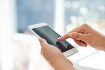 Image showing Success is one touch away. Cropped shot of an unrecognizable businesswoman using her smartphone inside of an office.