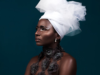 Image showing Serving up some serious style inspiration. Studio shot of an attractive young woman posing in traditional African attire against a blue background.