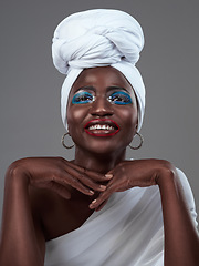 Image showing Shes a true African queen. Studio shot of an attractive young woman posing in traditional African attire against a grey background.