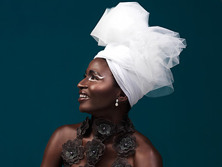 Image showing Fashion is a silent language. Studio shot of an attractive young woman posing in traditional African attire against a blue background.