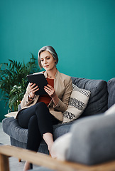 Image showing Analysing the data correctly. Cropped shot of an attractive mature businesswoman sitting alone and using a tablet in her home office.