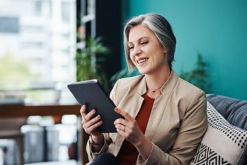 Image showing The figures are looking great online. Cropped shot of an attractive mature businesswoman sitting alone and using a tablet in her home office.