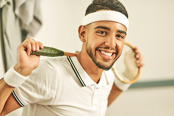 Image showing Squash is my passion. Portrait of a happy young man holding his squash racket in the locker room.