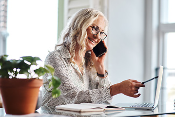 Image showing I have that right here...Cropped shot of an attractive senior businesswoman taking a phonecall while working from home.