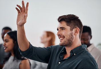 Image showing I dont mind volunteering for this one. Shot of a young businessman raising her hand during a conference.