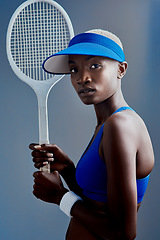 Image showing You are what you do So do GREAT things. Studio shot of a sporty young woman posing with a tennis racket against a grey background.