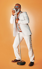 Image showing Be whatever you want to be. you might inspire others. Studio shot of a senior man wearing vintage clothes while singing into a microphone.