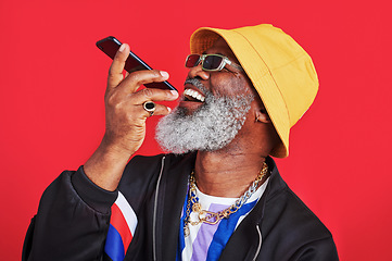 Image showing Sending voice messages to make everyones day. Studio shot of a mature man holding his cellphone against a red background.