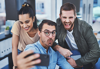 Image showing Never a dull moment when this dynamic team are together. Shot of a group of designers taking selfies together in an office.