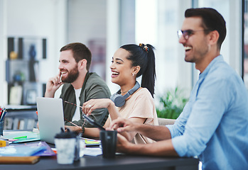 Image showing Optimism helps us persevere and conquer. Shot of a group of young designers listening to a presentation in an office.