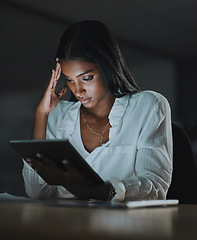 Image showing This feels like a dead end. Shot of a young businesswoman looking stressed out while using a digital tablet in an office at night.