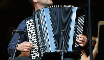 Image showing Accordion harmony. Cropped closeup shot of a musician playing an accordian.