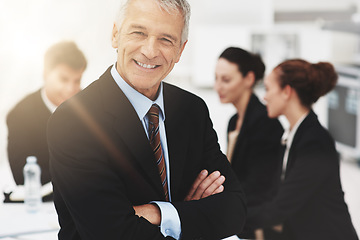 Image showing Business is very good indeed. Portrait of a mature businessman with colleagues standing in the background.