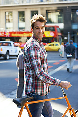 Image showing Feeling good about this day. Portrait of a handsome man traveling by bicycle in the city.