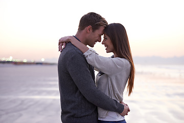 Image showing Theres nothing like young love. A young couple enjoying a romantic moment together at the beach.