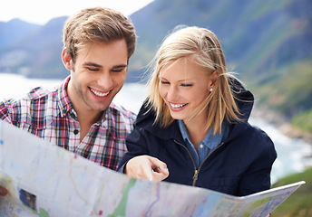 Image showing Getting lost can actually be fun. A shot of a young couple studying a map on their road trip.