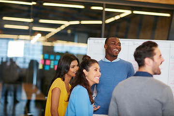 Image showing Success keeps the positivity alive. Cropped shot of a group of businesspeople talking in the boardroom.