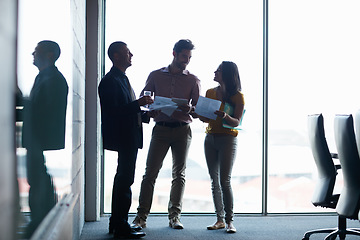 Image showing Going over the briefing for the meeting. Full length shot of three businesspeople talking in the boardroom.