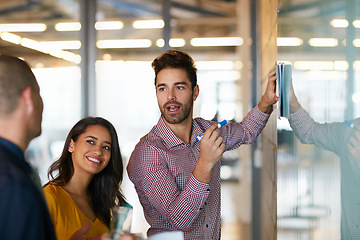 Image showing Hes on top of things. Cropped shot of three businesspeople working in the office.