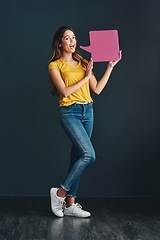 Image showing Perhaps its time to make our voice heard. Studio shot of a beautiful young woman holding a speech bubble.