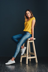 Image showing I enjoy the simple things in life. Studio shot of an attractive young woman against a dark background.