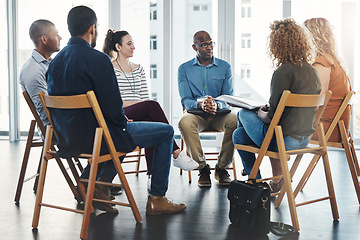 Image showing Gathered round for a meeting. Shot of a group of diverse creative employees having a meeting inside.