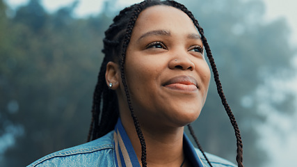 Image showing Face, thinking and a happy woman outdoor in nature to relax and breath fresh air to relax. Vacation, calm woods and closeup of a young african girl on a holiday or hike on misty morning with a smile