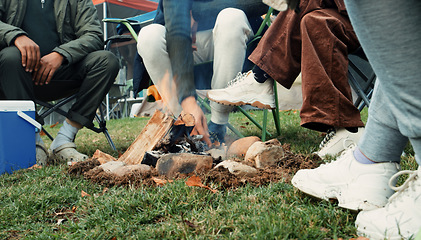 Image showing Wood, fire and warm hands on camping, trip or adventure in nature, forest or friends together at a bonfire in winter. Campfire, smoke and group relax on outdoor vacation, holiday or warming hand