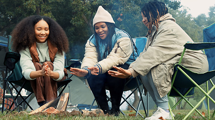 Image showing Friends camping, fire and warm hands with flame on trip or adventure in nature, forest or together at a bonfire in winter. Campfire, smoke and group relax on outdoor vacation, holiday or warming hand