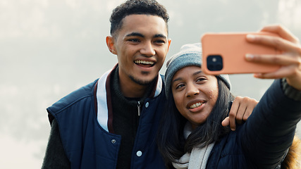 Image showing Selfie, travel and a couple hiking in nature together for adventure, fun or to explore the wilderness. Photograph, love and young people bonding while posing for a profile picture on social media