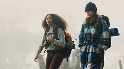 Image showing Travel, backpack and friends hiking in the mountain on a cold, overcast morning in nature together. Travel, freedom and adventure with women walking in the wilderness to explore while bonding