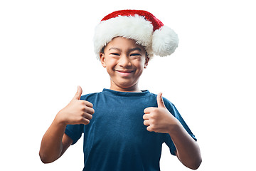 Image showing Happy boy, portrait smile and Christmas with thumbs up for success isolated on a transparent PNG background. Face of child, kid or teen smiling with thumb emoji, yes sign or like and festive hat