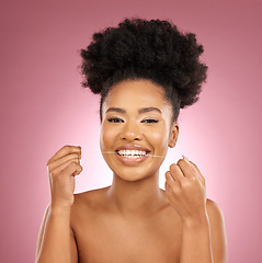 Image showing Black woman, portrait and floss teeth in studio for smile, dental hygiene and care of gum gingivitis on pink background. Happy female model, oral cleaning and thread for fresh breath or healthy habit