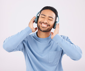 Image showing Headphones, music and man dancing with energy in a studio with album or playlist with technology. Happy, smile and Indian young male person doing a dance to song or radio isolated by white background